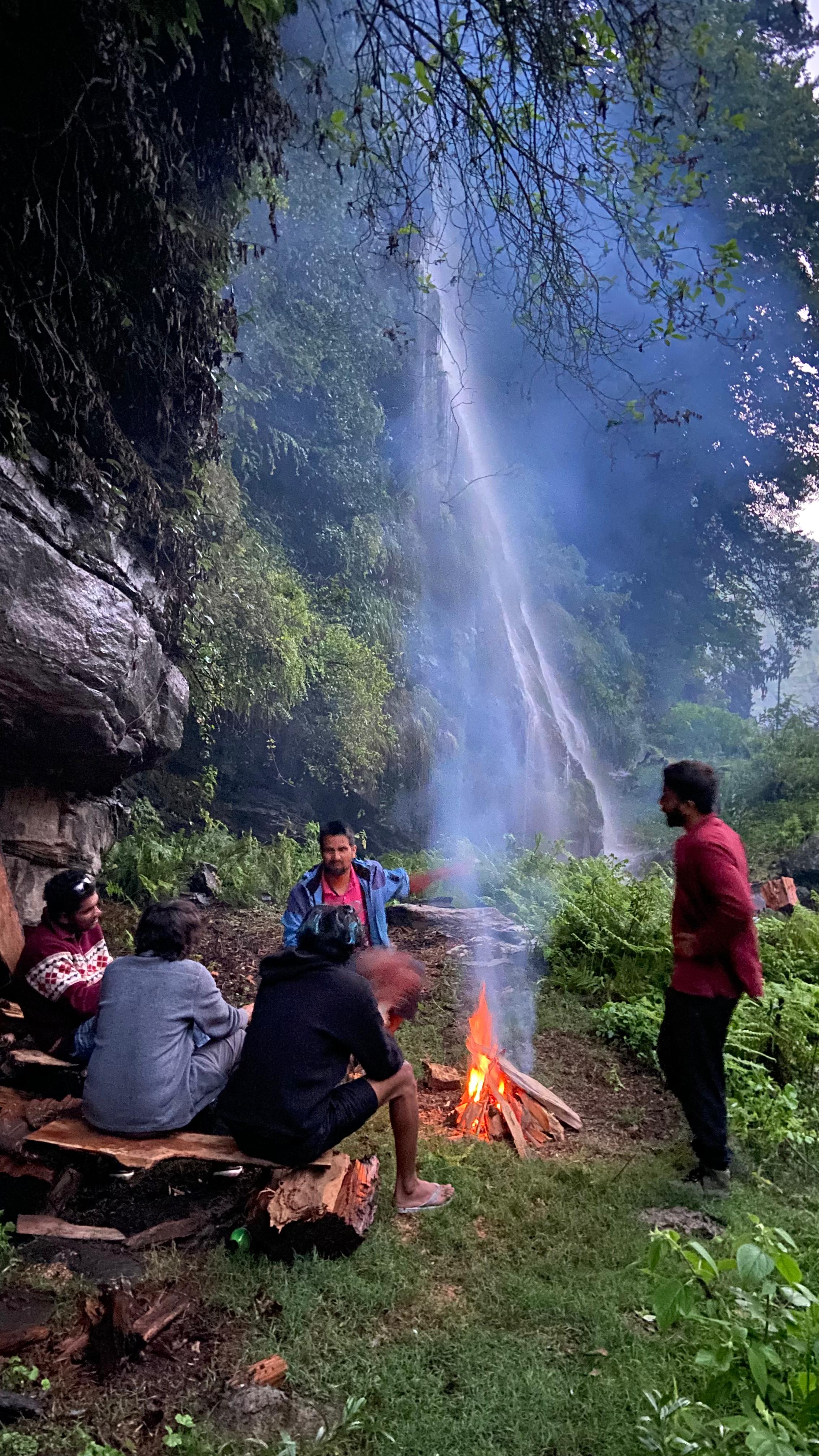 Campfire by a waterfall